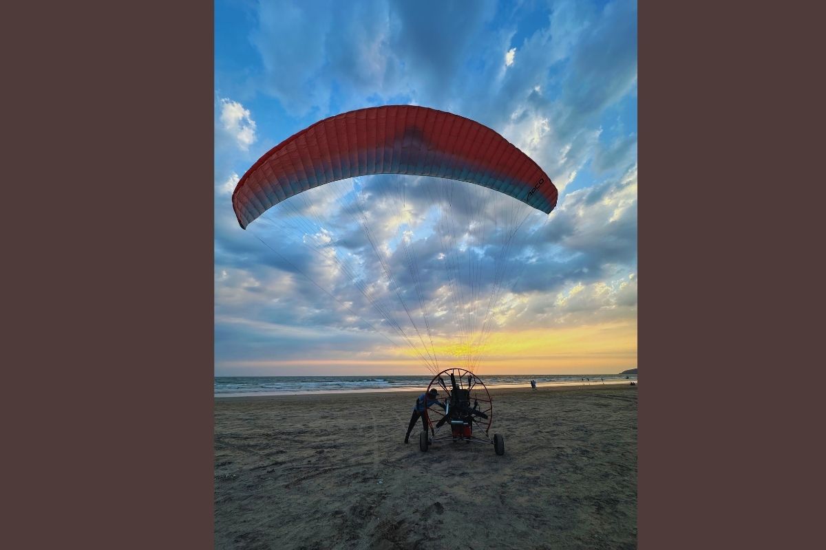 Paramotor wing on the beach at sunset
