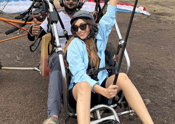 Guests laughing and chatting with the pilot before their paramotoring flight