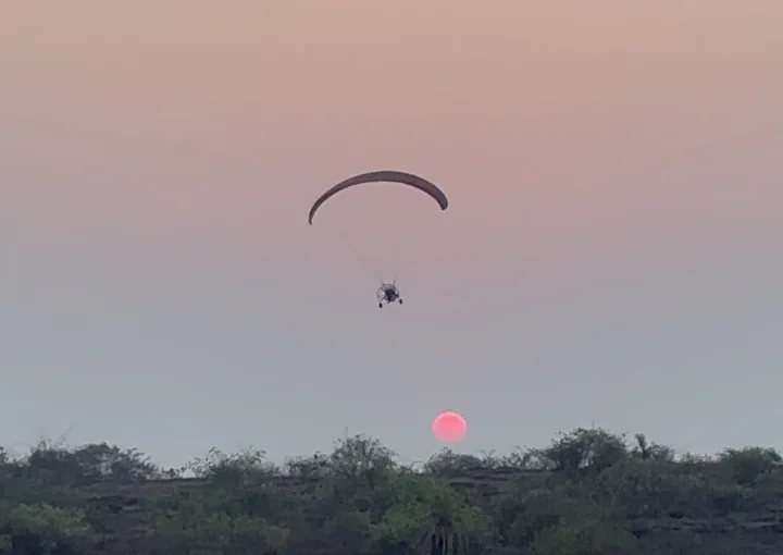 Paramotoring in the sunset sky.