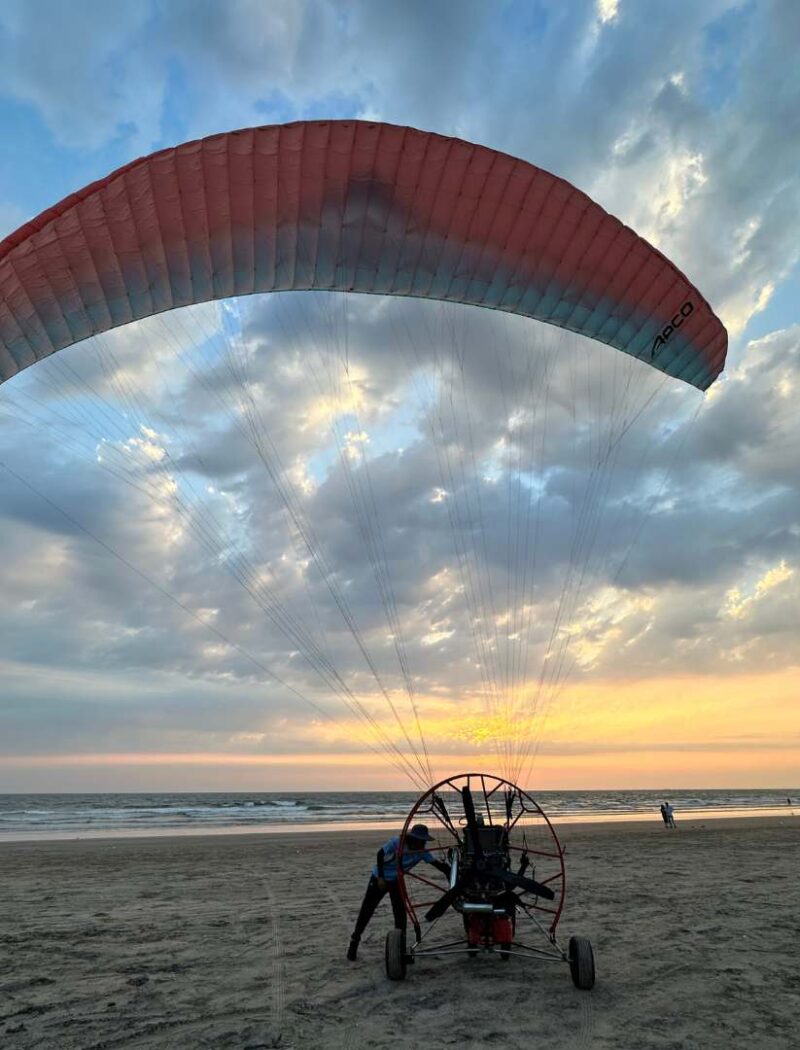 Paramotor flying low over the Arabian Sea near Goa